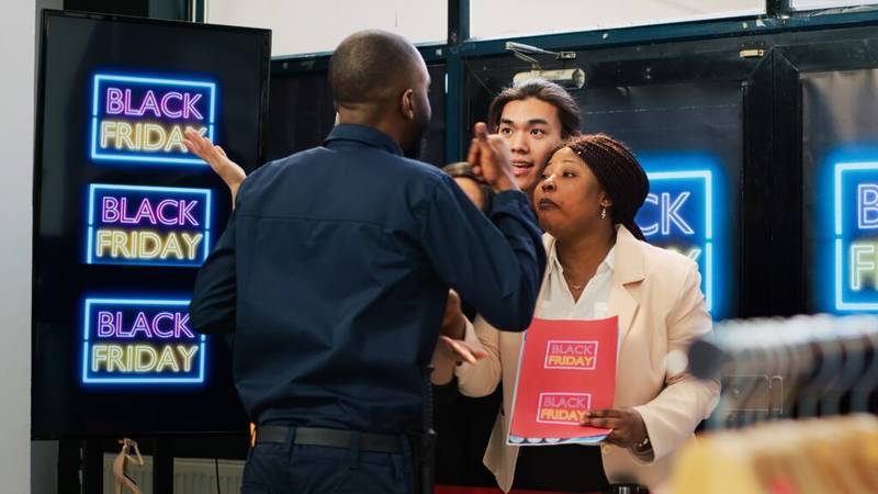 Retail staff managing a tense Black Friday queue—example of high-pressure moments at work.
